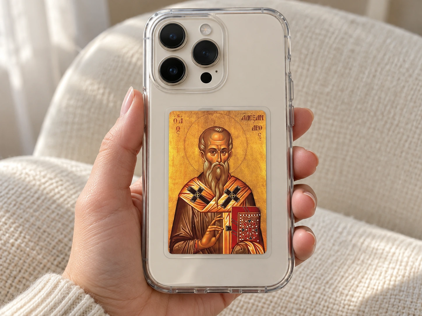 A laminated saint icon displayed inside a clear phone case